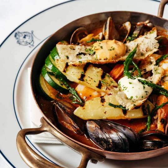 Cornish fish stew with fresh herbs and seafood at Bentley’s, a top seafood restaurant in Mayfair.