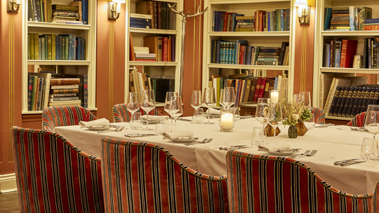 Intimate dining area with red velvet chairs at Bentley’s Oyster Bar, a seafood restaurant in Mayfair.