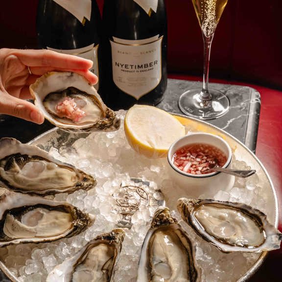 Oysters and champagne at Bentley's Oyster Bar & Grill seafood restaurant in Mayfair, London