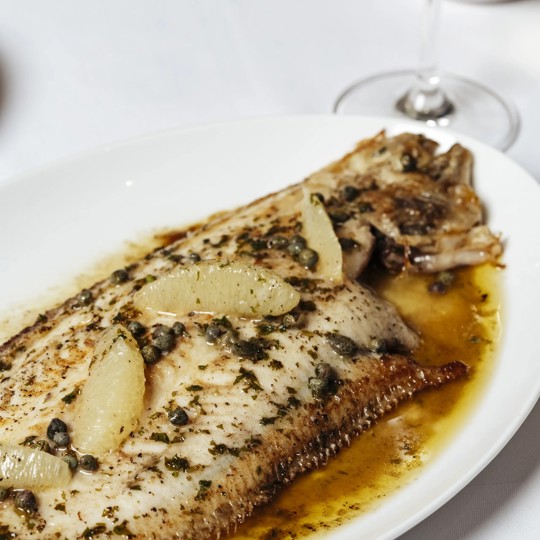 Dover sole dish with lemon and capers at a seafood restaurant in Mayfair.