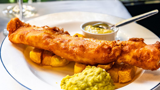 Golden fried fish and thick-cut chips served with tartar sauce at Bentley’s, a fish restaurant in Mayfair.