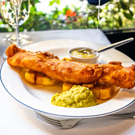 Golden fried fish and thick-cut chips served with tartar sauce at Bentley’s, a fish restaurant in Mayfair.