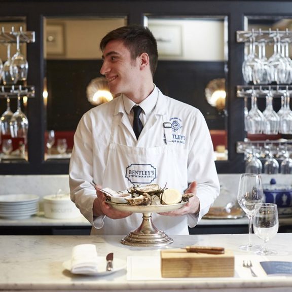 Oyster shucker at Bentley's Oyster Bar & Grill seafood restaurant in Mayfair, London
