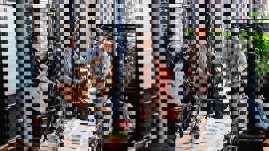 Guests enjoying drinks on a sunny patio at Bentley’s Oyster Bar, a seafood restaurant in Mayfair.