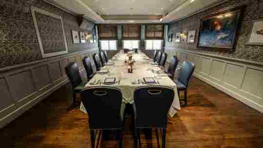 Intimate dining setup with white tablecloths and elegant decor at Bentley’s Oyster Bar, a top fish restaurant in Mayfair.