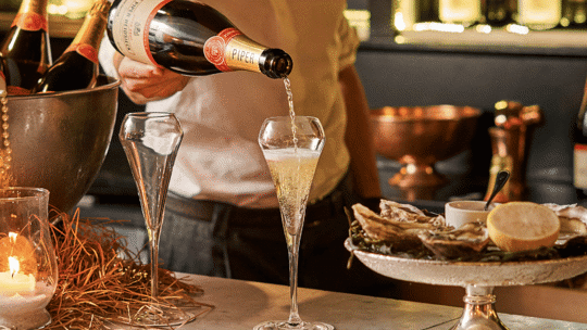 Pouring Piper champagne at Bentley's Oyster Bar & Grill in Mayfair, London